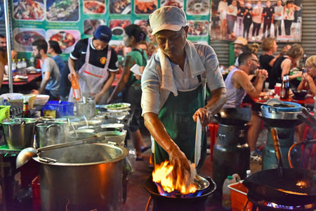 BANGKOK, THAILAND - JAN 28, 2018: Cooking Chinese street food sold in Bangkok Chinatown.のeditorial素材