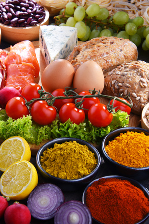 Composition with assorted organic food products on wooden kitchen table.の写真素材