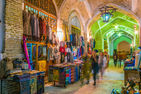 BUKHARA, UZBEKISTAN - APR 30, 2019: Evening street sales in the Historic Centre of Bukhara,...