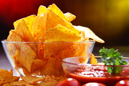 Composition with glass bowl of potato chips and dipping sauce.の写真素材