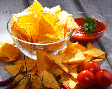Composition with glass bowl of potato chips and dipping sauce.の写真素材