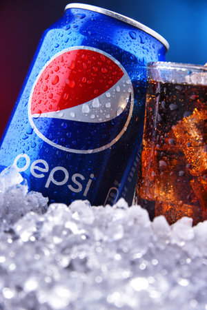 POZNAN, POL - AUG 13, 2019: A can and a glass of Pepsi, a carbonated soft drink produced and...
