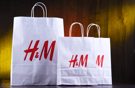 POZNAN, POL - AUG 28, 2019: H and M paper shoping bags; Hennes and Mauritz AB is a Swedish multinational clothing-retail company, It operates over 4,500 stores in 62 countries worldwideのeditorial素材