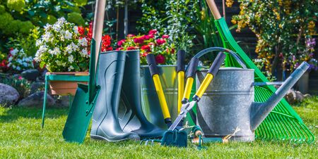Gardening tools on the grass in the garden.の写真素材