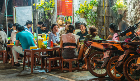 HANOI, VIETNAM - SEP 18, 2019: People eating street food in Old Quarter of Hanoi, Vietnam by nightのeditorial素材