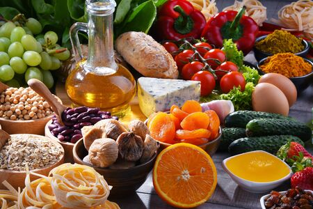 Composition with assorted organic food products on wooden kitchen table.の写真素材