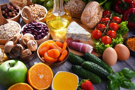 Composition with assorted organic food products on wooden kitchen table.の写真素材