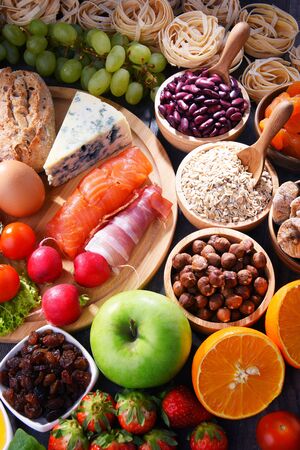 Composition with assorted organic food products on wooden kitchen table.の写真素材