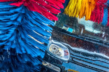 Car going through an automated car wash machine.