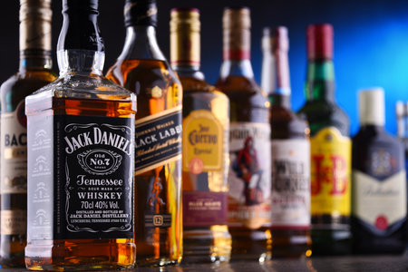 POZNAN, POLAND - DEC 20, 2019: Bottles of assorted global liquor brands including whiskey, vodka, gin and liqueurのeditorial素材