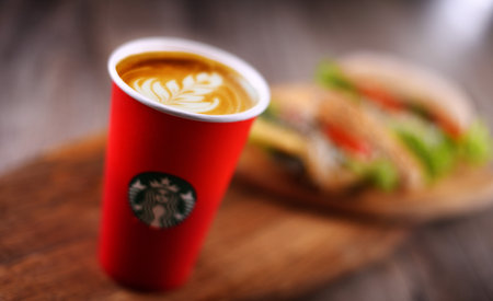 POZNAN, POLAND - DEC 17, 2019: Cup of Starbucks, the name of coffee company and coffeehouse chain, founded in Seattle, Wa. USA, in 1971; now the largest business of this kind in the world.のeditorial素材