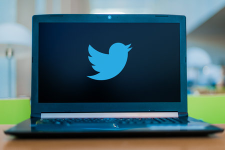 POZNAN, POL - DEC 11, 2019: Laptop computer displaying logo of Twitter, an American online microblogging and social networking serviceのeditorial素材