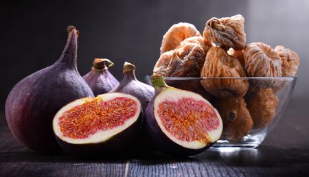 Composition with fresh and dried figs on wooden table.の写真素材