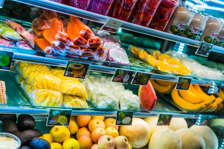 SINGAPORE - MAR 3, 2020: Packages with fresh fruits displayed in a commercial refrigeratorのeditorial素材