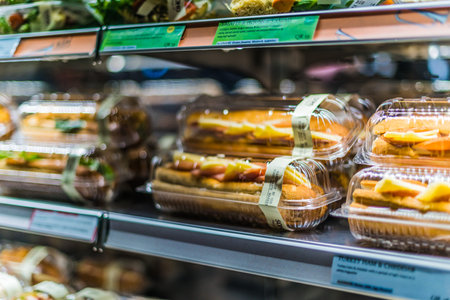 DOHA, QATAR - FEB 28, 2020: Pre-packaged foods displayed in a commercial refrigeratorのeditorial素材