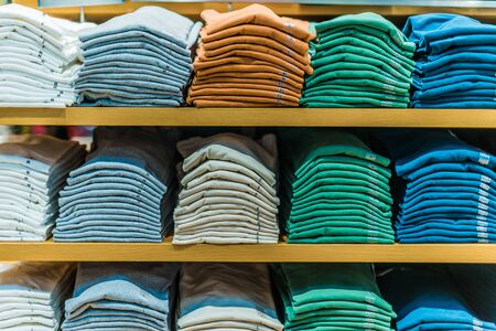Clothing products on the shelf in a clothing store.の写真素材