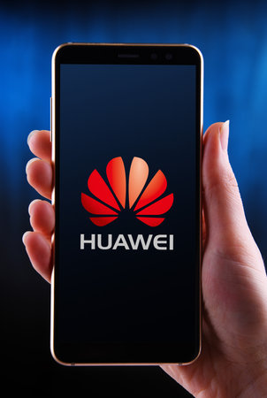 POZNAN, POL - MAY 21, 2020: Hands holding smartphone displaying logo of Huawei, a multinational telecommunications equipment and consumer electronics manufacturer, headquartered in Shenzhen, Chinaのeditorial素材