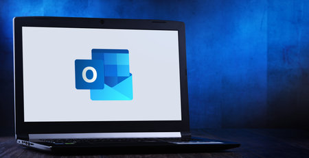 POZNAN, POL - JUL 11, 2020: Laptop computer displaying logo of Microsoft Outlook program, part of the Office family software and services developed by Microsoftのeditorial素材