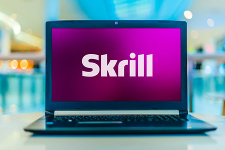 POZNAN, POL - MAY 21, 2020: Laptop computer displaying logo of Skrill (formerly Moneybookers), an e-commerce business that allows payments and money transfers to be made through the Internetのeditorial素材