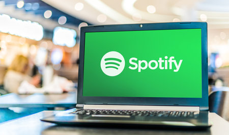 POZNAN, POL - APR 28, 2020: Laptop computer displaying logo of Spotify, a Swedish audio streaming platform that provides music and podcasts from record labels and media companiesのeditorial素材