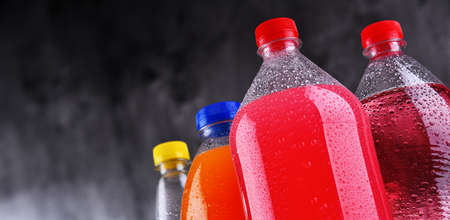 Plastic bottles of assorted carbonated soft drinks in variety of colorsの写真素材