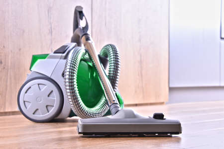 Canister vacuum cleaner for home use on the floor panels in the apartment.の写真素材