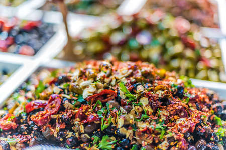 Assorted olives put up for sale on the italian street market stall.の写真素材