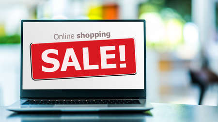 Laptop computer displaying a commercial sale sign on internet shopping website. E-commerce