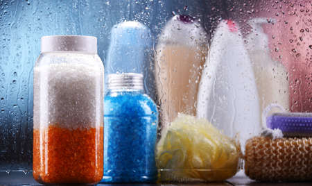 Different containers of body care products in the bathroom.