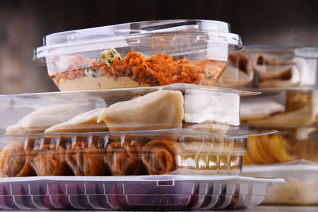 A variety of prepackaged food products in plastic boxes.