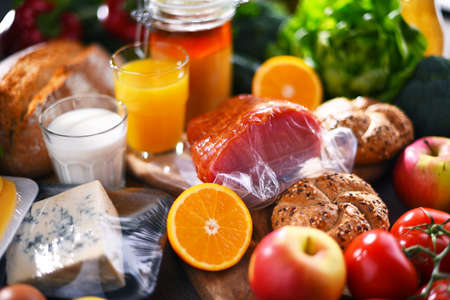 Assorted organic food products on wooden kitchen table.