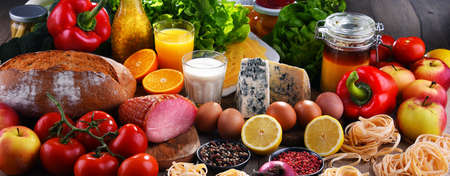 Assorted organic food products on wooden kitchen table.