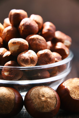 Bowl with hazelnuts on wooden table. Delicaciesの写真素材