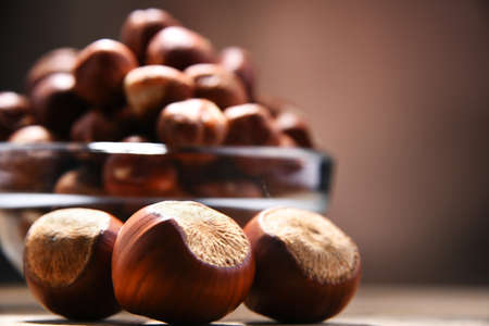 Bowl with hazelnuts on wooden table. Delicacies