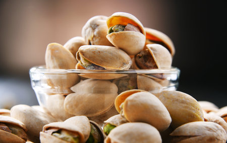 Composition with bowl of in shell pistachios. Delicaciesの写真素材