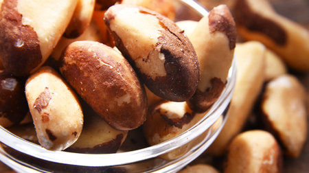 Composition with a bowl of shelled brazil nuts. Delicaciesの写真素材