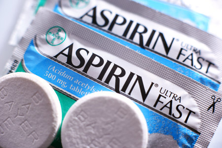 POZNAN, POL - FEB 17, 2021: Aspirin pills, a brand of popular medication, the first and best-known product of Bayer, German multinational pharmaceutical company headquartered in Leverkusenのeditorial素材