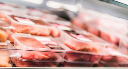 Meat products put up for sale in a supermarket commercial refrigerator