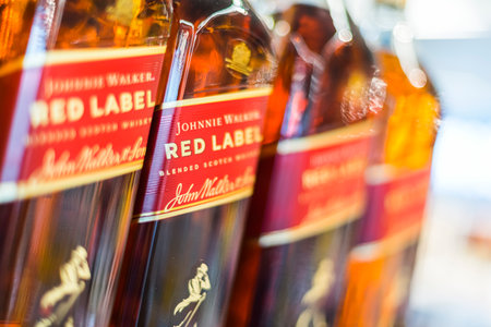 POZNAN, POL - APR 13, 2021: Johnnie Walker Scotch whiskey bottles put up for sale in a supermarketのeditorial素材