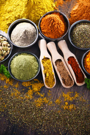 Variety of spices on wooden kitchen table.の写真素材