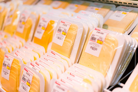 POZNAN, POL - APR 28, 2021: Cheese put up for sale in a supermarket's dairy departmentのeditorial素材