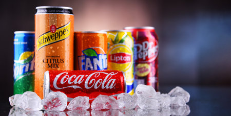 POZNAN, POL - MAY 13, 2021: Cans of popular soft drink brands including Coca Cola, Fanta, Dr Pepper,...