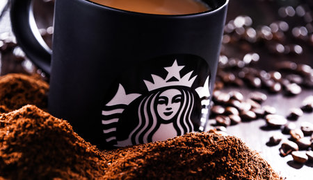 POZNAN, POL - AUG 19, 2021: Cup of Starbucks, the name of coffee company and coffeehouse chain, founded in Seattle, Wa. USA, in 1971; now the largest business of this kind in the world.のeditorial素材