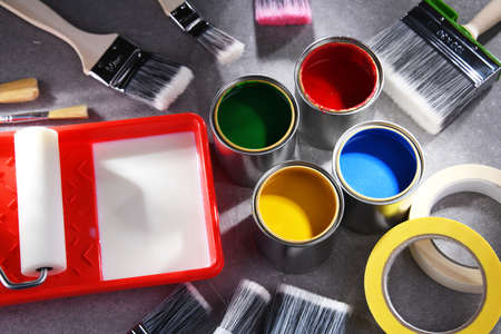 Paint cans and paintbrushes of different size for home decorating purposes.の写真素材