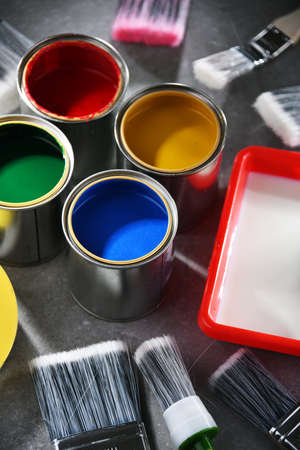 Paint cans and paintbrushes of different size for home decorating purposes.の写真素材