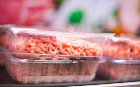 Meat products put up for sale in a supermarket commercial refrigeratorの写真素材