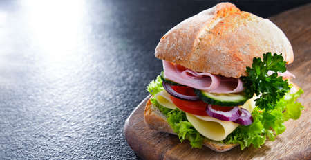 Sandwich with cheese and ham and fresh vegetablesの写真素材