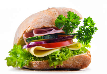 Sandwich with cheese and ham and fresh vegetables isolated on white.の写真素材