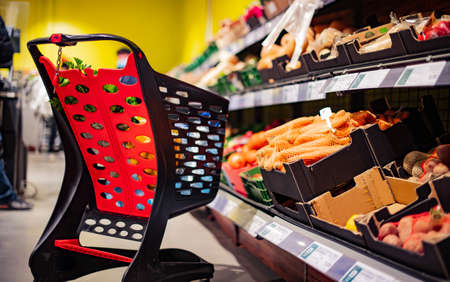 A shopping cart with grocery products in a supermarketの写真素材