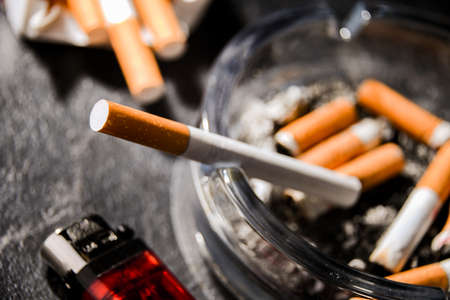 Composition with an ashtray and cigarettes.の写真素材